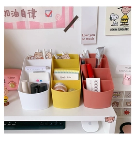 Three-compartment tiered desk organizer in white, yellow and brown for stationery
