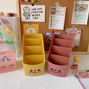 Pastel yellow and pink desk organizer with cute smiley face for pens and brushes