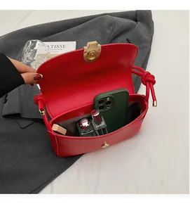 Spacious interior of red leather handbag showing room for phone and cosmetics