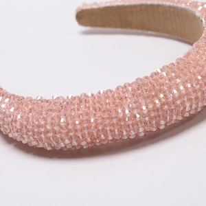 Macro shot of hand-beaded light pink headband with faceted crystal beads and liner