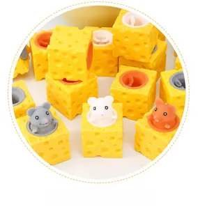 Macro shot of cheese squeeze toy set with popping mice in grey, white and orange colors