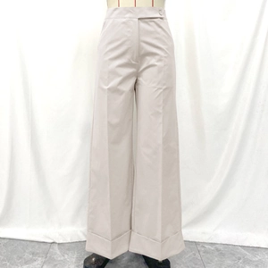 Light beige high-waisted wide-leg trousers with side button and cuffed hems