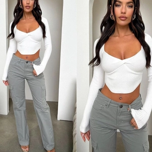 White ribbed long sleeve crop top with V-neck twist front and grey high waist cargo pants