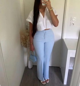 Detail showing white short sleeve crop shirt with lapel collar and chest pockets for summer