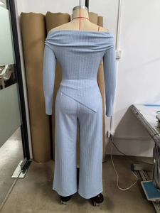 Detailed back view of light blue cable knit set with off-shoulder top and wide-leg trousers