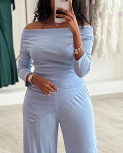 Detail of light blue ribbed fabric and asymmetrical hem on the off-shoulder top set