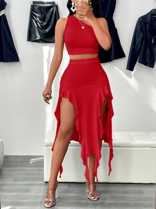 Detail of red two-piece set featuring asymmetrical ruffle skirt and halter crop top
