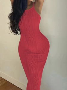 Detail of red knitted bodycon dress showing delicate vertical wave texture and slim fit