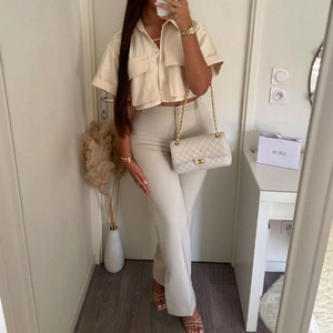 Chic beige short sleeve button-down shirt with chest pockets and matching trousers