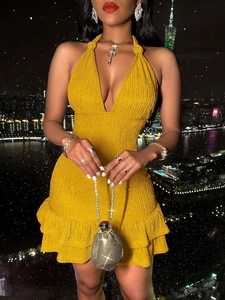 Sexy halter neck yellow dress with ruffles against a bokeh city night background