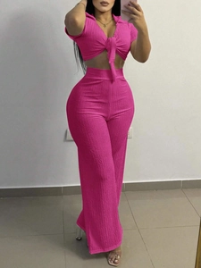 Detail view of pink ribbed fabric texture on V-neck tie-up crop top and wide-leg pants