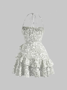 Detail of floral halter dress with double-layered ruffle hem and vintage botanical print