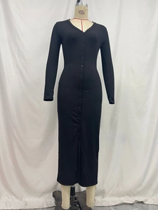 Detail of black ribbed knit dress showing the V-neckline and button-down front closure