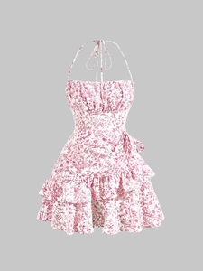Detail of floral halter neck dress with double-layered ruffled hem and retro print