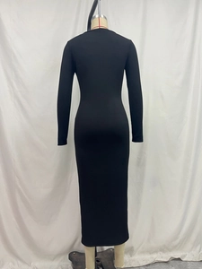 Rear view of a black ribbed knit bodycon dress with long sleeves and maxi length