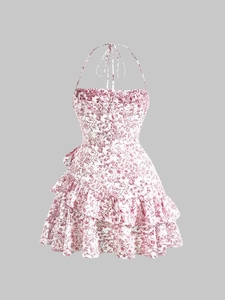 Detail of floral print halter neck dress with tiered ruffle hem and tie-up neckline