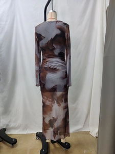 Detailed macro of abstract marble print texture on long sleeve mesh maxi dress