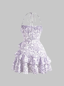Detail of floral halter dress showing purple flower print and ruffled layered hemline