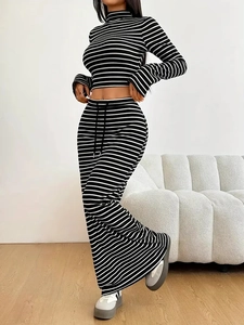 Women's chic black and white striped two-piece set with long sleeve crop top and maxi skirt