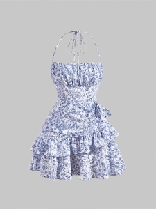 Floral halter neck sun dress with tiered ruffle hem and blue floral pattern on white fabric