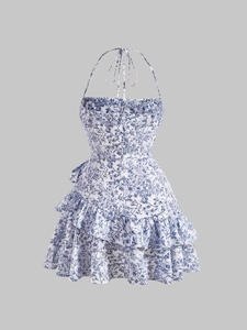 Detail view of floral halter neck dress featuring double-layered ruffle hem and back ties