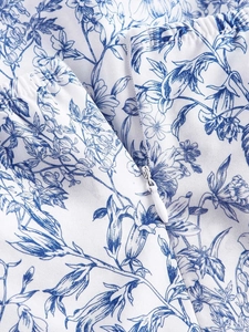 Detail of floral summer dress with invisible zipper and elastic waist pleats