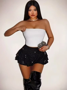Women's sexy tiered black sequin mini skirt and white tube top with sparkling finish