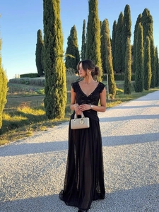 Close-up of elegant V-neck lace bodice and delicate sheer chiffon skirt of the dress