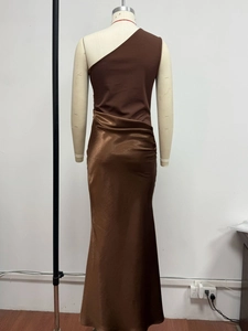 Detail view of the chocolate brown satin dress with a one-shoulder cut and ruched waist