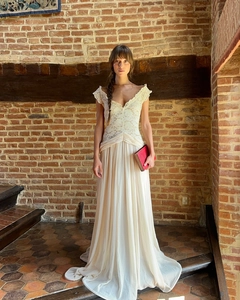 Detail of elegant V-neck lace bodice and pleated chiffon skirt on an ivory evening dress