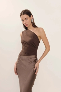 Detail of a brown one-shoulder satin dress with elegant ruching and premium glossy fabric
