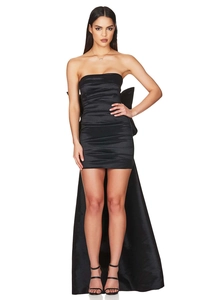 Detailed back view of a black strapless mini dress featuring a large bow and long train