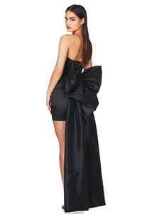 Detailed back view of black satin cocktail dress with an oversized bow and elegant train
