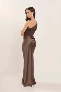 Detail of elegant dark brown one-shoulder gown featuring matte top and satin silk skirt