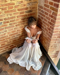 Detailed view of the delicate white lace bodice and off-shoulder neckline on the dress