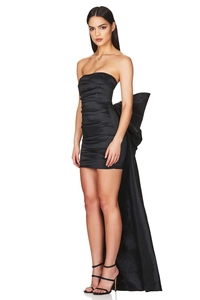 Close-up of black strapless mini dress featuring ruched satin fabric and oversized back bow