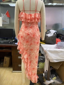 Back view of pink floral chiffon dress featuring layered ruffles and slit hem detail