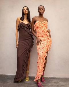 Detail of cross-neck chiffon dresses with ruffle trim and high slit floral patterns