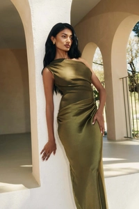 Detailed close-up of dark green satin dress featuring shoulder pleats and side draping