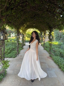 Detailed close-up of elegant V-neck lace bodice and flowing chiffon maxi dress