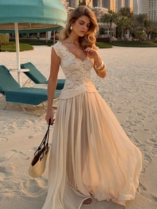 Close-up of white floral crochet lace bodice with V-neckline on a bohemian maxi dress