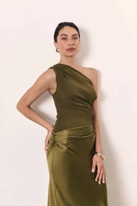 Detail of emerald green one-shoulder dress showing side ruffles and satin skirt texture