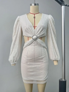 Detail of white sequin dress featuring a waist cutout with a crystal ring embellishment