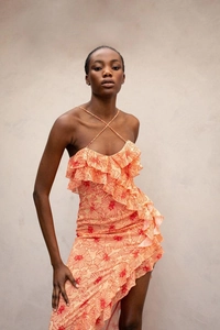 Detailed ruffled hem and cross-strap halter neck on peach floral chiffon midi dress