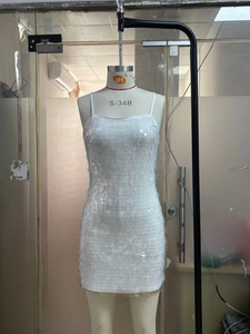 Detail view of the shimmering white sequins and delicate spaghetti straps on this mini dress