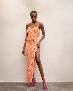 Detail of orange floral maxi dress with ruffle trim and high side slit design