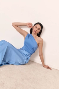 Detailed close-up of sky blue satin fabric on elegant one-shoulder long evening dress