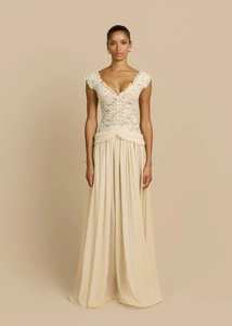 Close-up of elegant v-neck lace bodice and pleated chiffon skirt on a beige dress