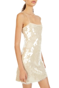 Detail view of large champagne sequins on backless slim fit party mini dress