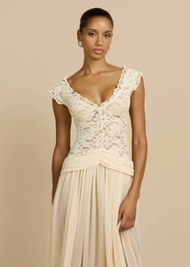 Detailed view of the V-neck lace bodice and pleated chiffon waist on an elegant evening gown